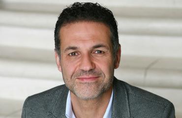 Khaled Hosseini fuller shot publicity photo (c) 2013 by Elena Seibert